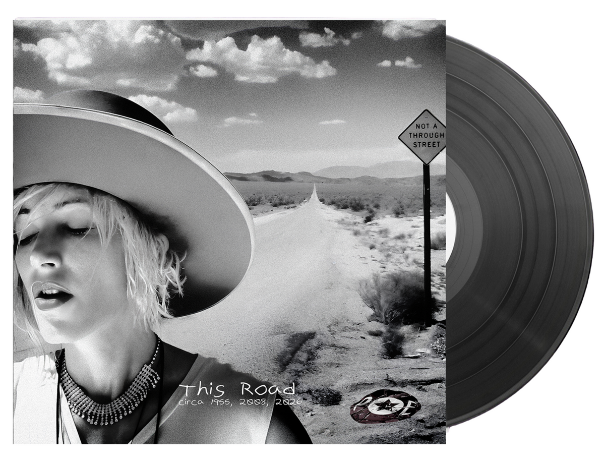 This Road 12" vinyl cover art - a woman in a wide-brimmed hat beside a desert road with a Not A Through Street sign